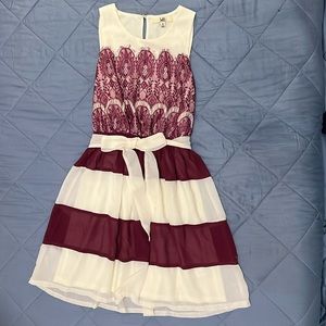 This is a gorgeous holiday dress with a red and white striped skirt and lace top